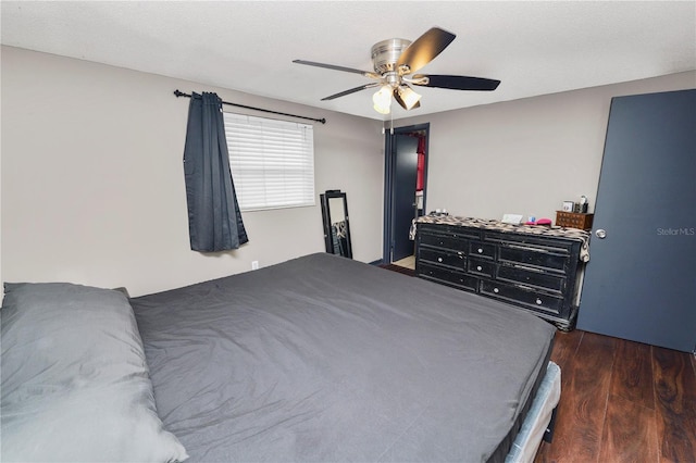 bedroom featuring dark wood-type flooring and ceiling fan