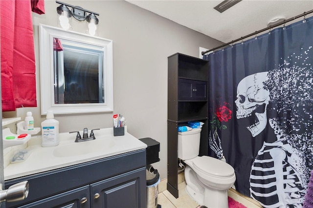 bathroom featuring toilet, vanity, tile patterned flooring, and a shower with shower curtain