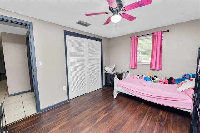 bedroom featuring ceiling fan, a closet, and hardwood / wood-style flooring