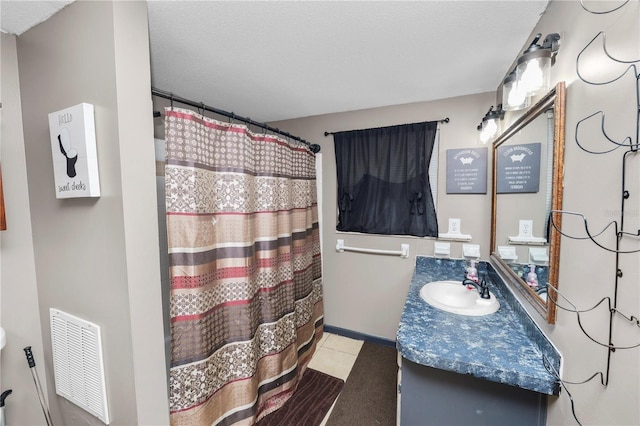 bathroom with vanity, tile patterned floors, a shower with shower curtain, and a textured ceiling