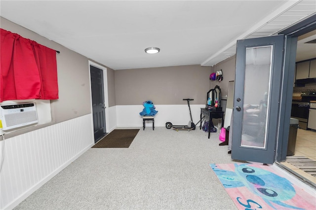 exercise room with carpet floors and a wall mounted AC