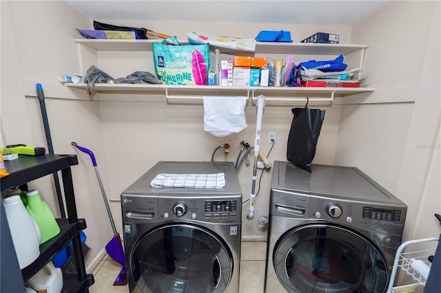 laundry room with independent washer and dryer and light tile patterned flooring