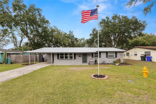 ranch-style home with a front lawn and a carport