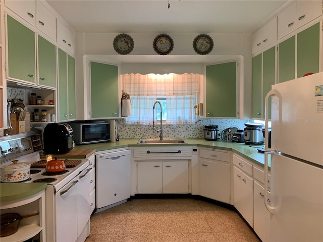 kitchen featuring white appliances, tasteful backsplash, white cabinets, and sink