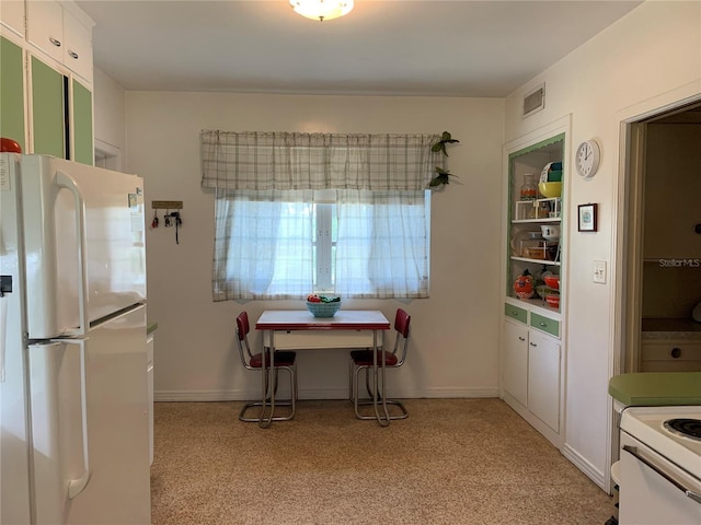 kitchen with white appliances and white cabinets