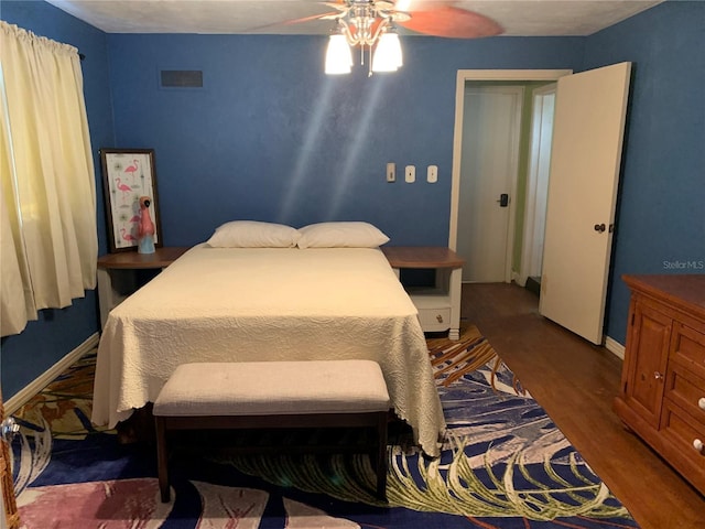 bedroom with ceiling fan and dark hardwood / wood-style floors