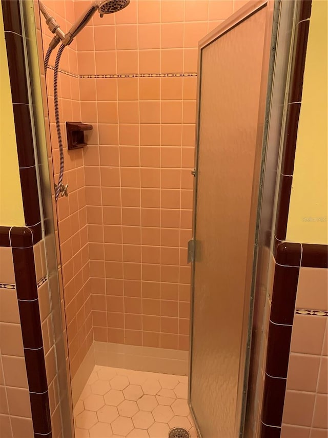 bathroom with a shower with door