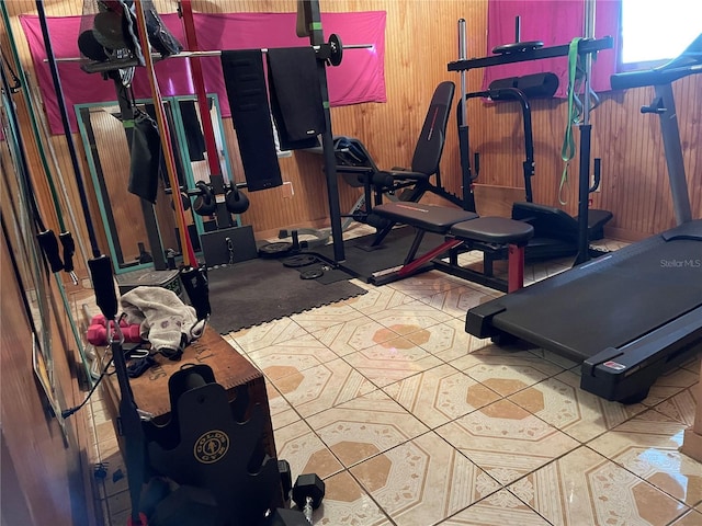 exercise room featuring wood walls