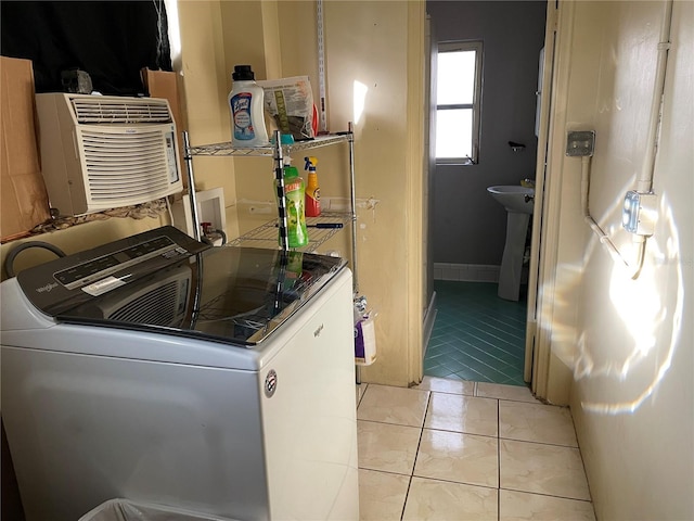 washroom with washer and dryer and light tile patterned floors