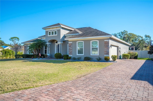 view of front of house featuring a front lawn and a garage