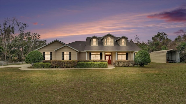 view of front of property featuring a lawn and a carport