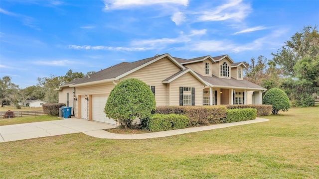 view of front of property with a front yard and a garage