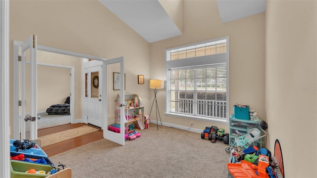 game room featuring vaulted ceiling, carpet flooring, and french doors