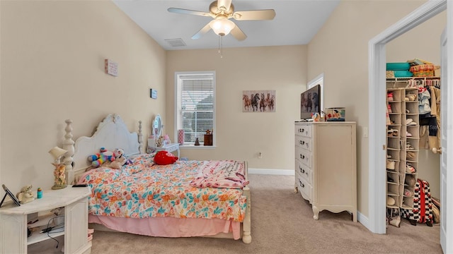 bedroom with ceiling fan and light carpet