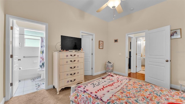 carpeted bedroom with connected bathroom and ceiling fan