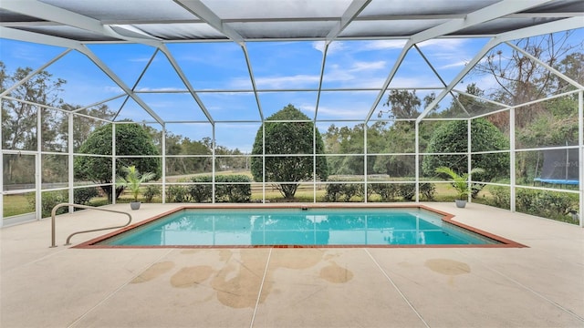 view of swimming pool featuring a lanai and a patio area