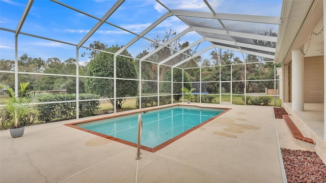 view of swimming pool featuring a patio area and glass enclosure