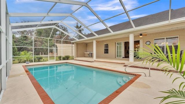 view of swimming pool featuring ceiling fan, a lanai, and a patio area