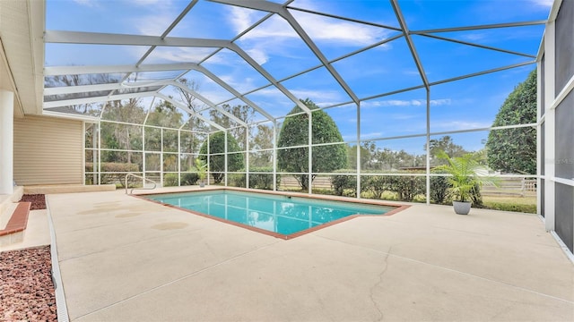 view of swimming pool featuring a lanai and a patio area