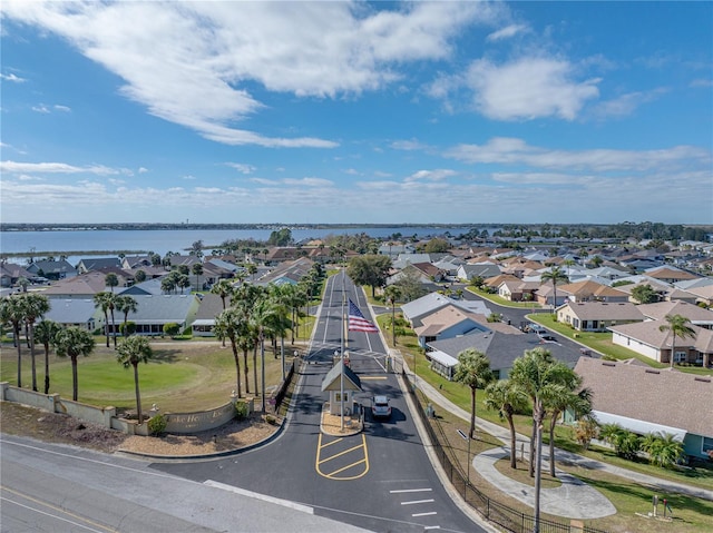 drone / aerial view featuring a water view and a residential view