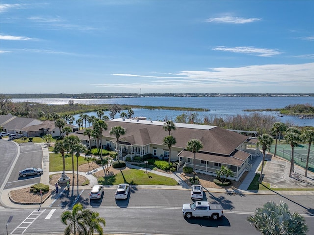 drone / aerial view featuring a water view and a residential view