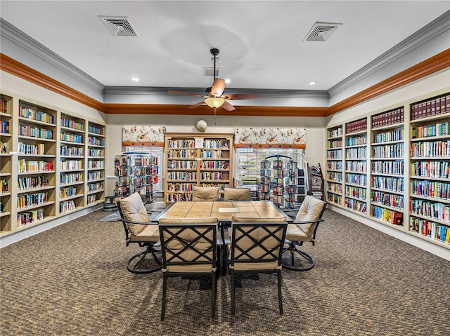 interior space with ceiling fan, carpet floors, ornamental molding, and visible vents