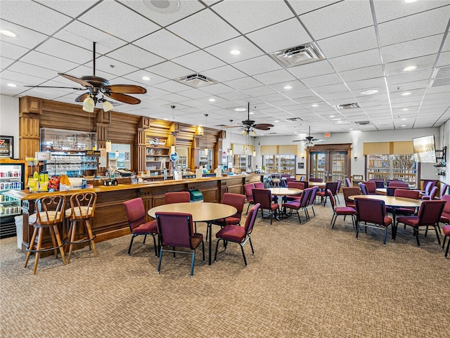 dining area with carpet floors, a bar, and visible vents