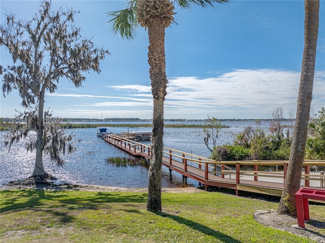 view of dock featuring a yard and a water view