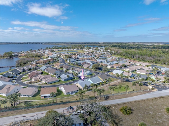 drone / aerial view featuring a residential view and a water view