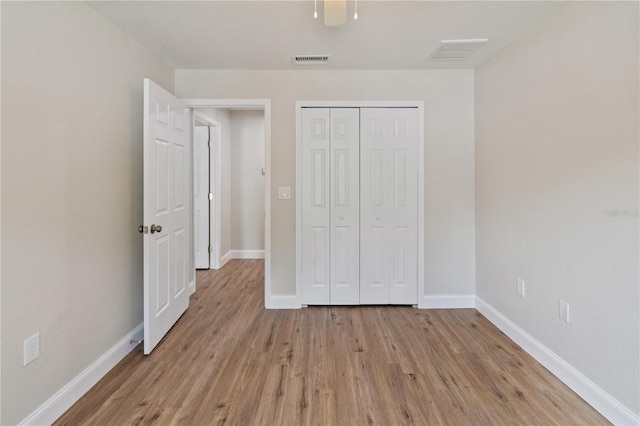 unfurnished bedroom featuring a closet and light wood-type flooring