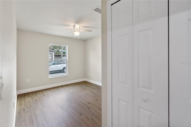 unfurnished bedroom with ceiling fan and light hardwood / wood-style flooring