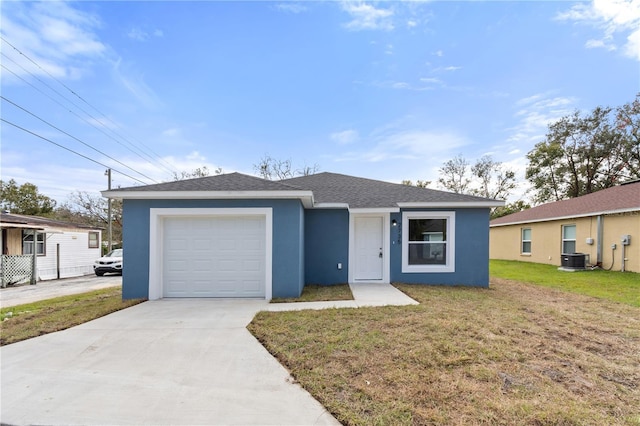 view of front of property with a garage, cooling unit, and a front yard