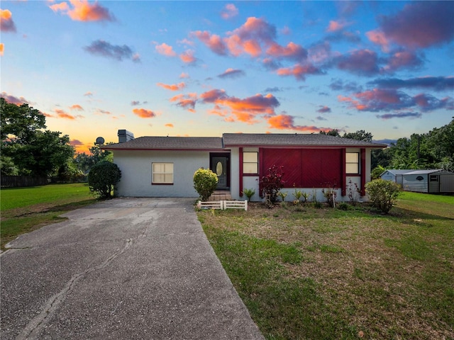 ranch-style home with a lawn