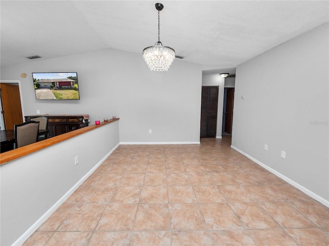 unfurnished dining area with lofted ceiling, a textured ceiling, an inviting chandelier, and light tile patterned floors