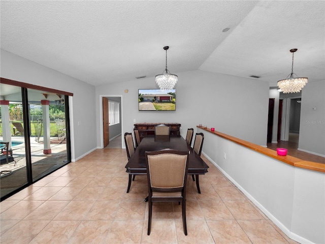 dining space featuring light tile patterned floors, a textured ceiling, a chandelier, and vaulted ceiling