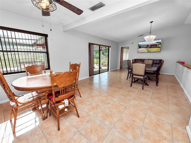 tiled dining area featuring a textured ceiling, vaulted ceiling with beams, and ceiling fan with notable chandelier