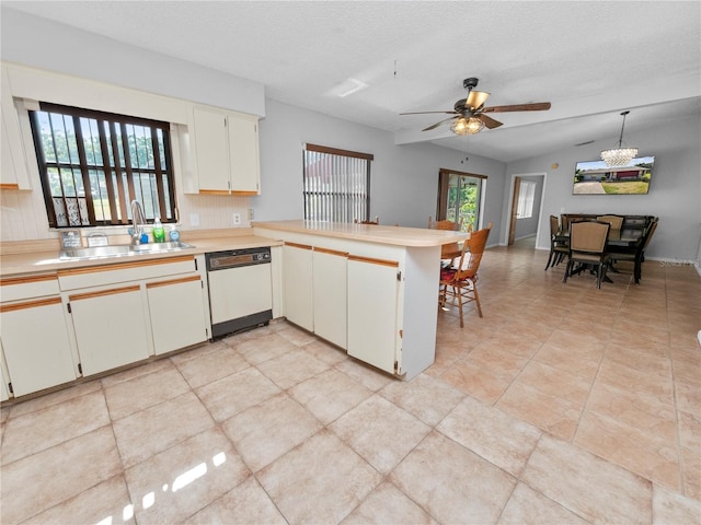 kitchen featuring sink, a textured ceiling, dishwasher, kitchen peninsula, and pendant lighting