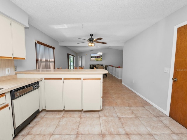 kitchen with white dishwasher, white cabinets, vaulted ceiling, and kitchen peninsula