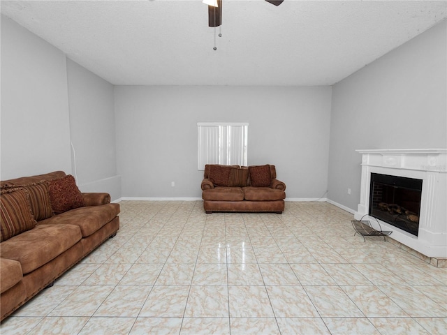 tiled living room with a textured ceiling and ceiling fan