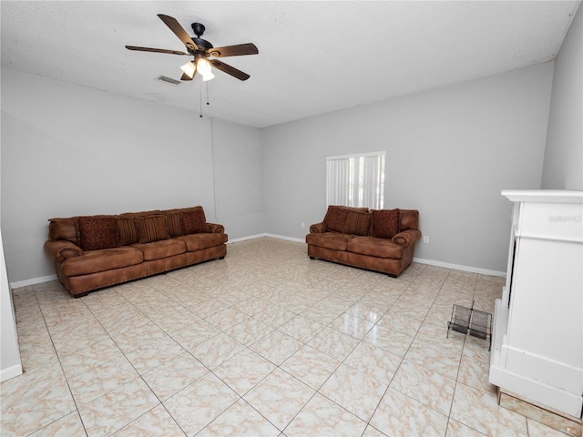 living room with ceiling fan and a textured ceiling