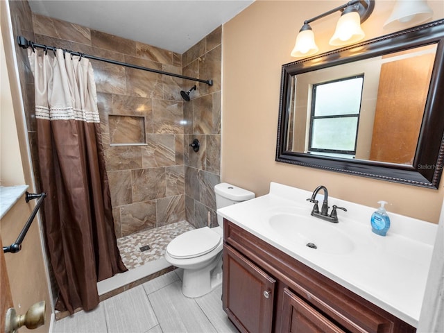 bathroom featuring toilet, a shower with shower curtain, and vanity