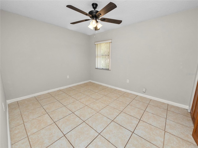 unfurnished room featuring a textured ceiling, light tile patterned flooring, and ceiling fan