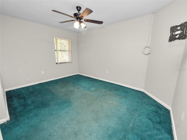 carpeted spare room with a textured ceiling and ceiling fan