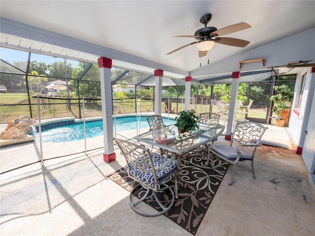 view of swimming pool with a lanai, ceiling fan, and a patio