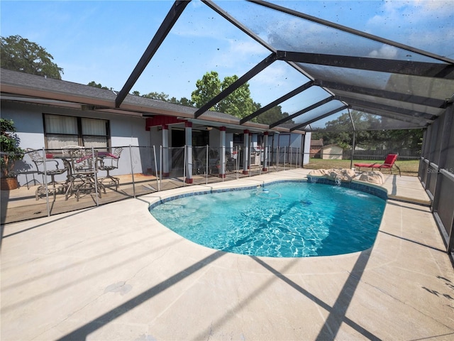 view of swimming pool with a lanai, pool water feature, and a patio area