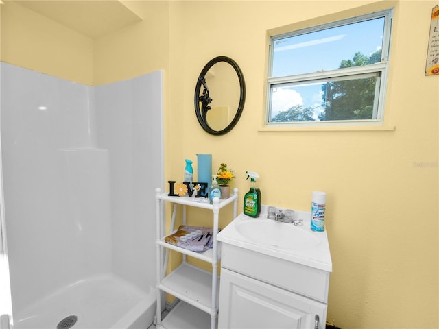 bathroom with a shower and vanity