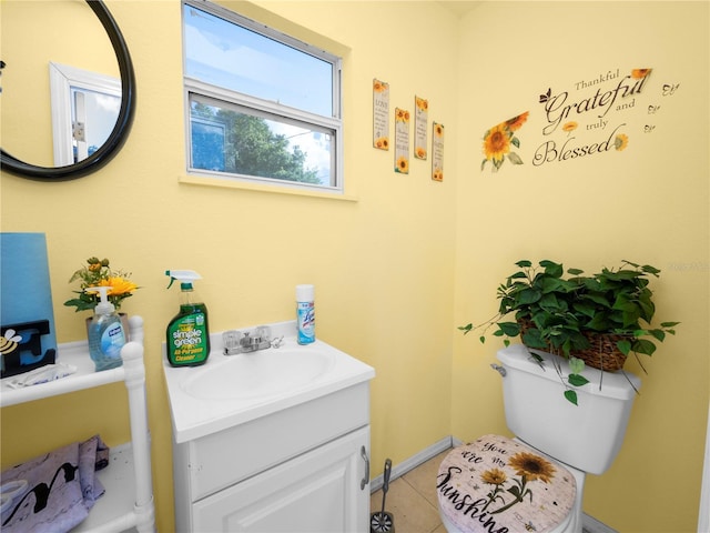 bathroom with toilet, tile patterned flooring, and vanity