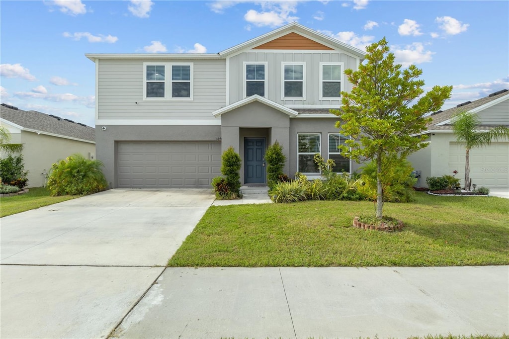 view of front of home featuring a front yard and a garage