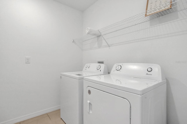 laundry area featuring separate washer and dryer and light tile patterned floors