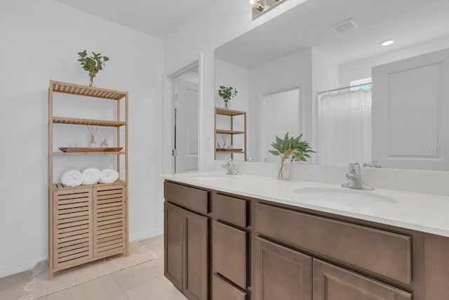 bathroom with vanity, tile patterned floors, and walk in shower